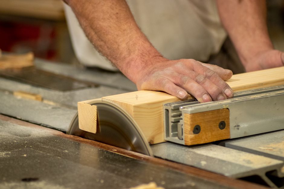 Skilled carpenter building precise kitchen cabinets in a workshop